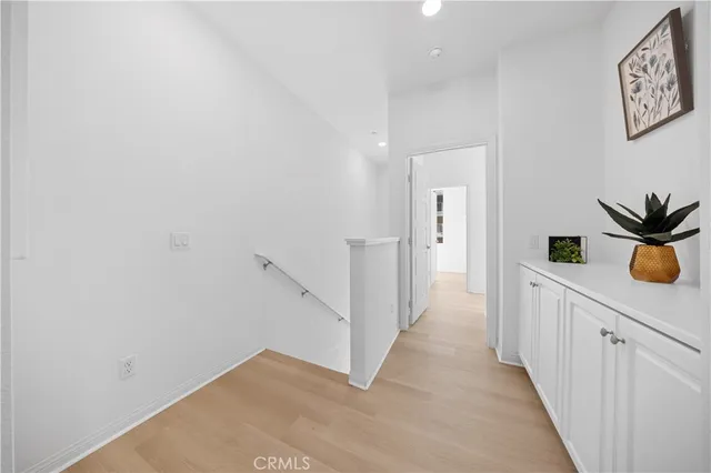 a view of a hallway with wooden shelves