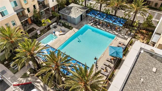 an aerial view of a house with a garden and lake view