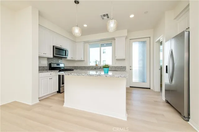 a view of a kitchen with a sink a refrigerator and a stove