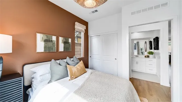 a bedroom with a bed and a mirror