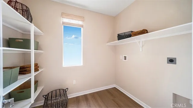 a view of storage and utility room with wooden floor and stairs
