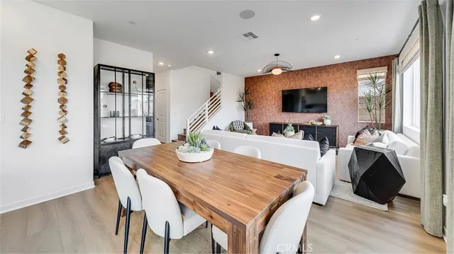 a living room with furniture a flat screen tv and a large window