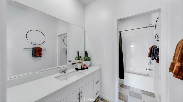 a bathroom with a sink mirror and shower
