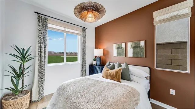 a bedroom with a bed and a potted plant