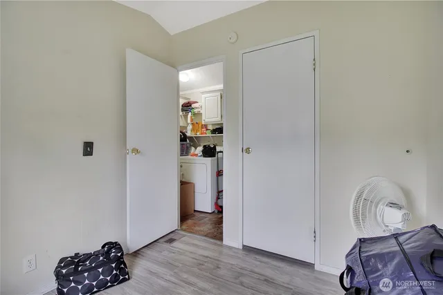a view of workspace with wooden floor cabinet and a window