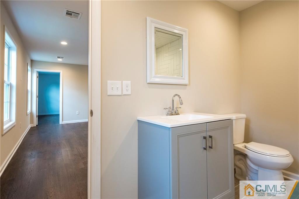 27 Windsor Road Edison, NJ 08817 - Photo 22 of 33 a bathroom with a toilet a sink and mirror