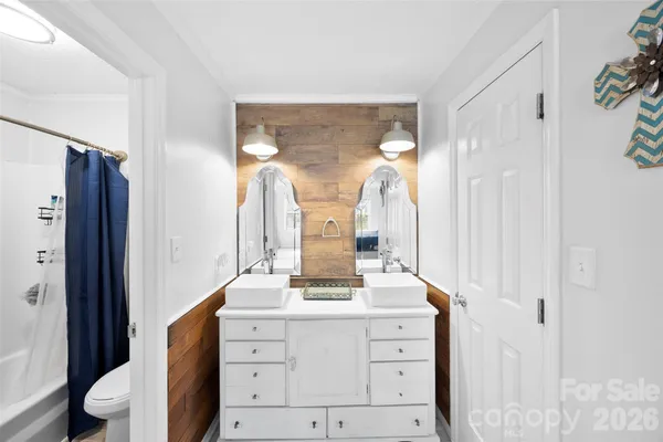 a bathroom with a double vanity sink and mirror