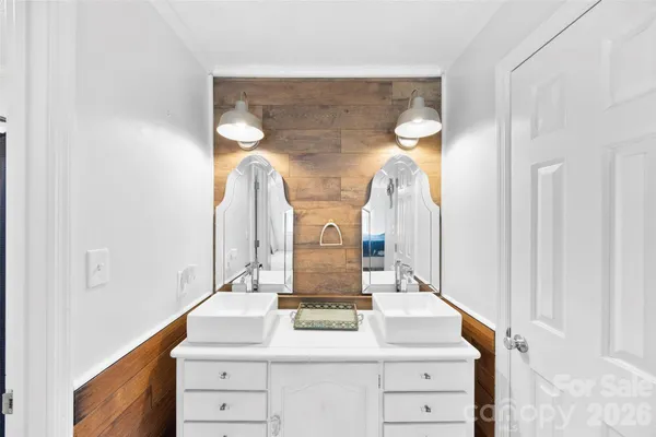 a bathroom with a double vanity sink and a mirror