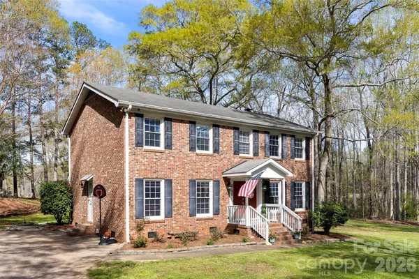 a front view of a house with yard porch and furniture