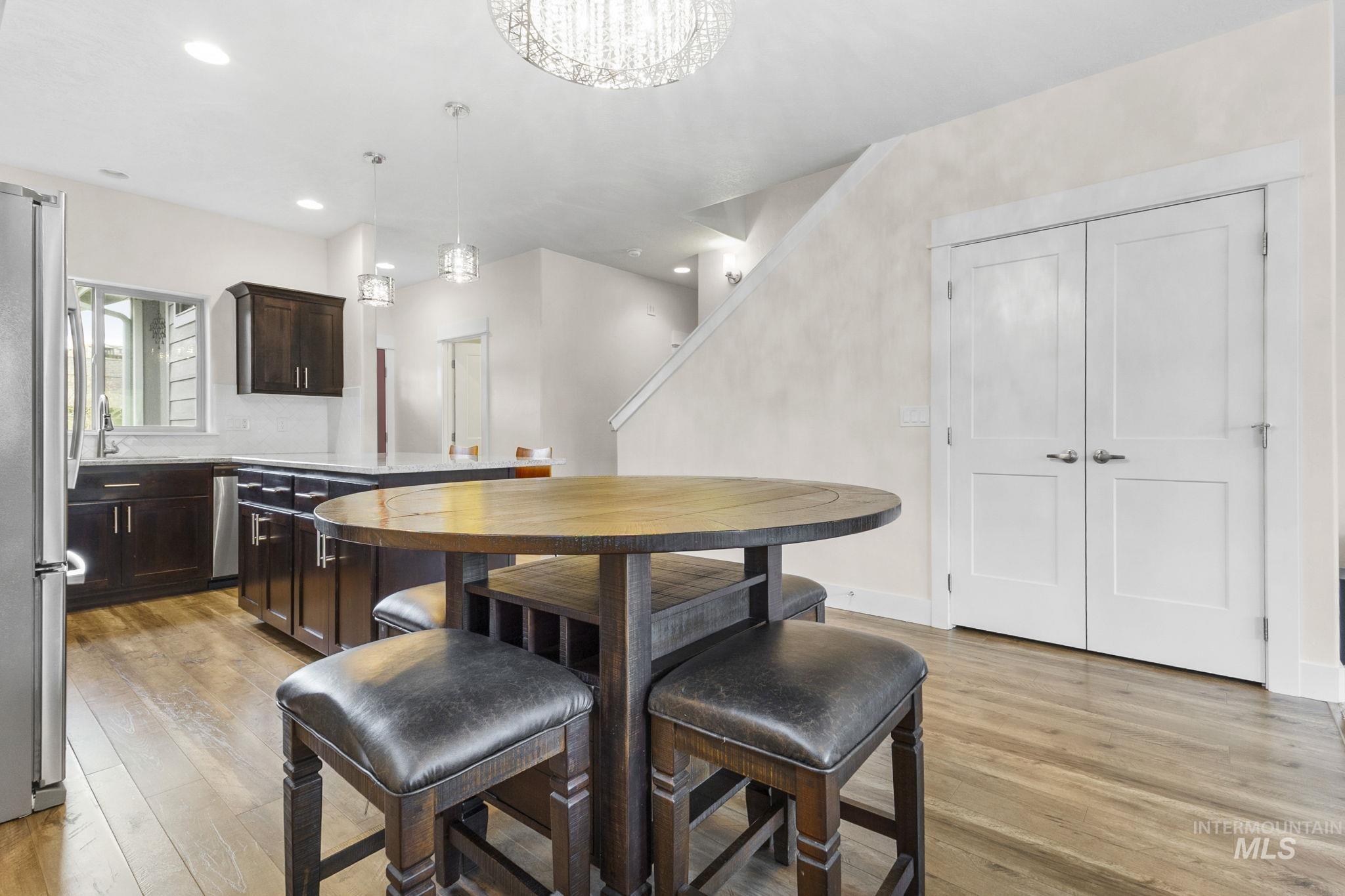 18293 North Streams Edge Way Boise, ID 83714 - Photo 12 of 50 Dining space with light wood-style floors and a chandelier