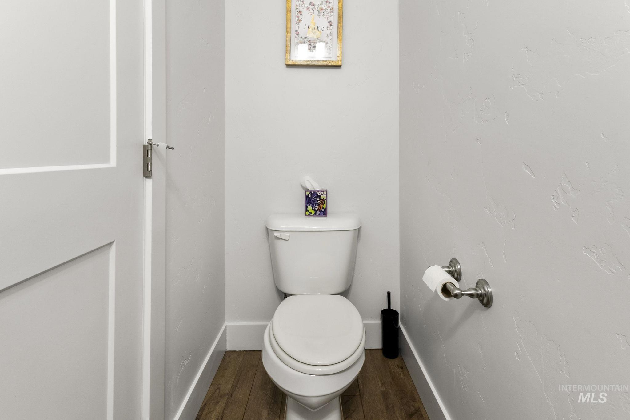 18293 North Streams Edge Way Boise, ID 83714 - Photo 14 of 50 Bathroom featuring toilet and dark wood-type flooring
