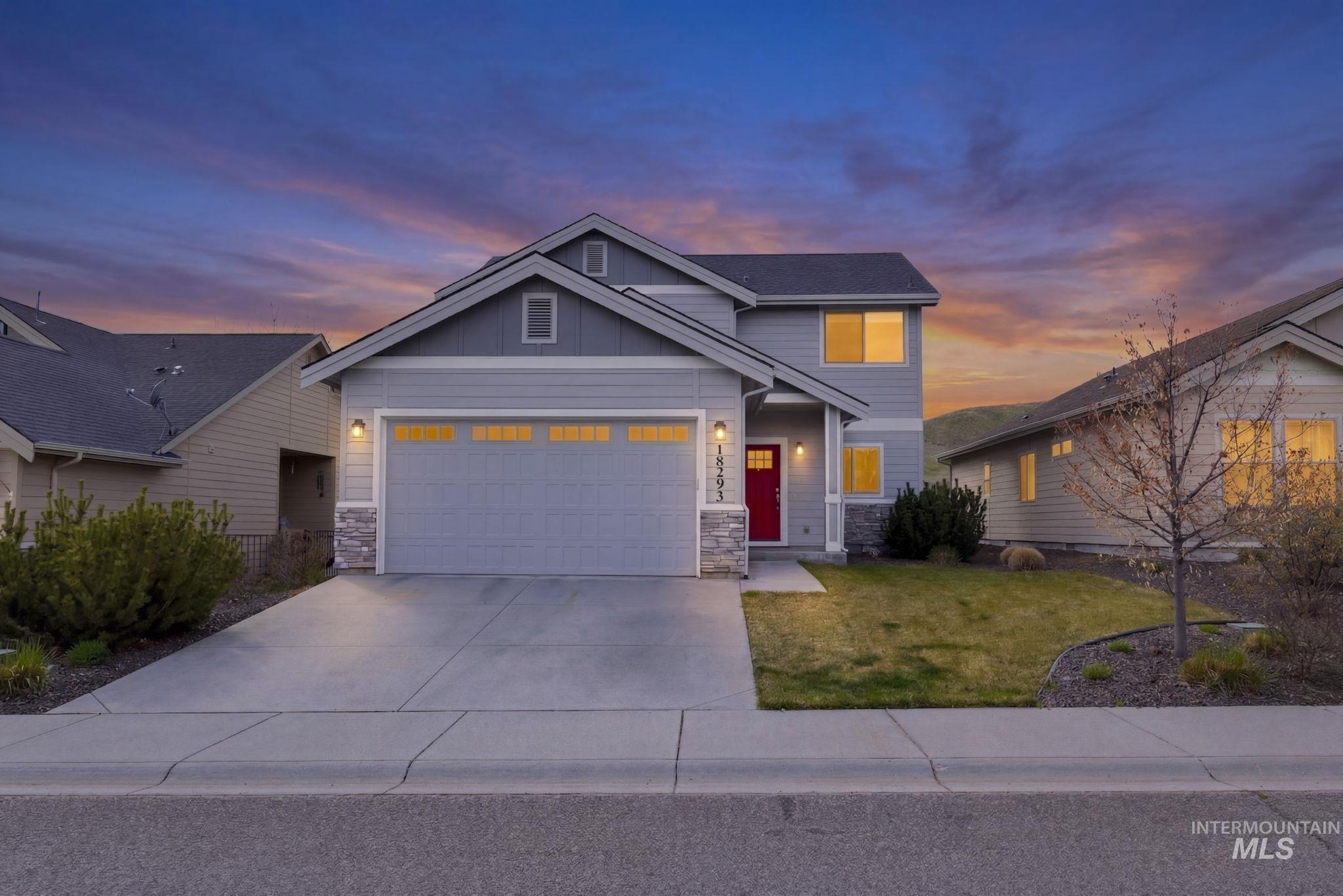 18293 North Streams Edge Way Boise, ID 83714 - Photo 2 of 50 View of front of home with stone siding, board and batten siding, a garage, and driveway