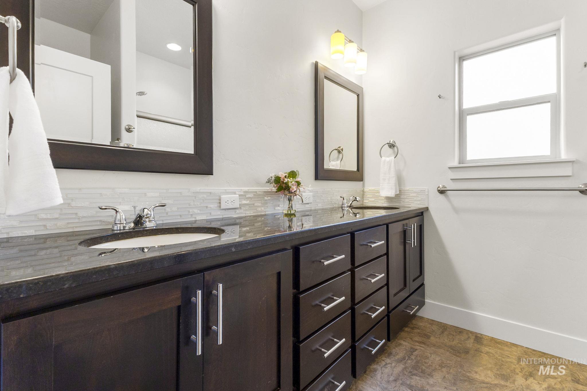 18293 North Streams Edge Way Boise, ID 83714 - Photo 20 of 50 Full bathroom featuring double vanity and decorative backsplash