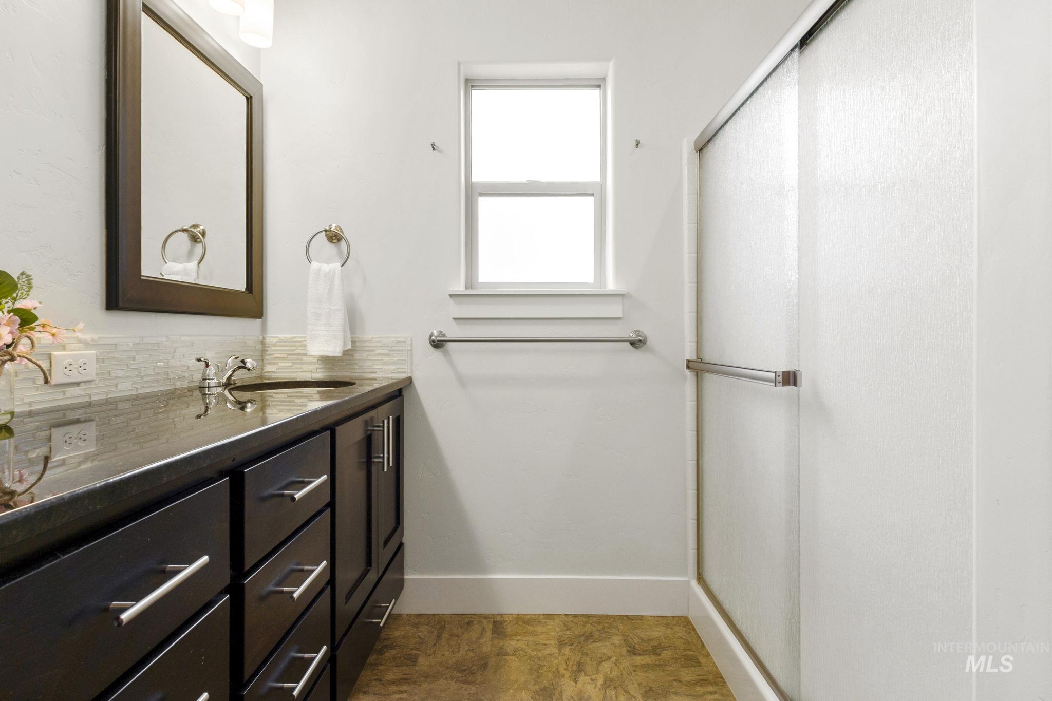 18293 North Streams Edge Way Boise, ID 83714 - Photo 21 of 50 Full bath with vanity, a shower stall, and tasteful backsplash