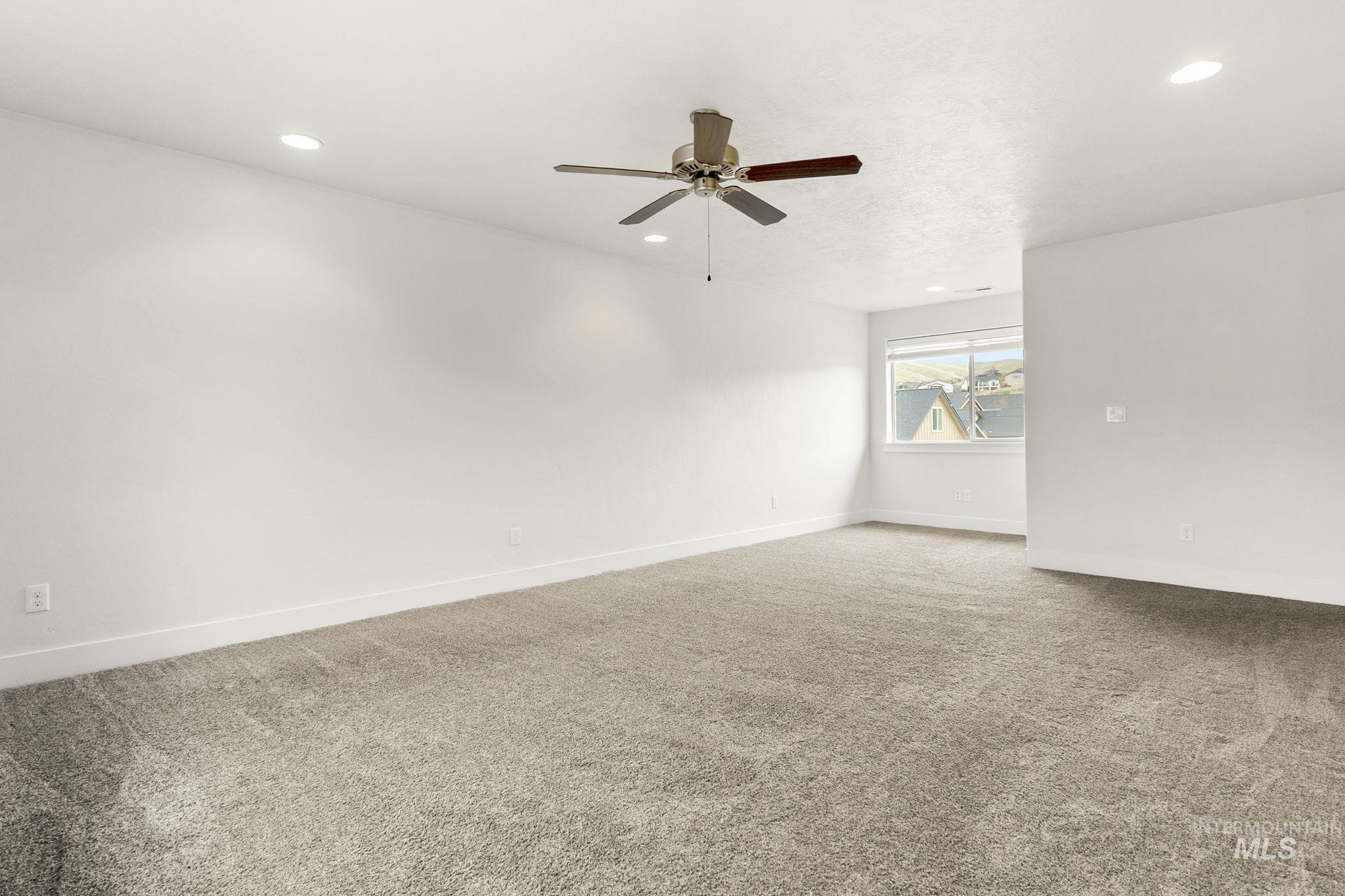 18293 North Streams Edge Way Boise, ID 83714 - Photo 23 of 50 Carpeted empty room with a ceiling fan and recessed lighting