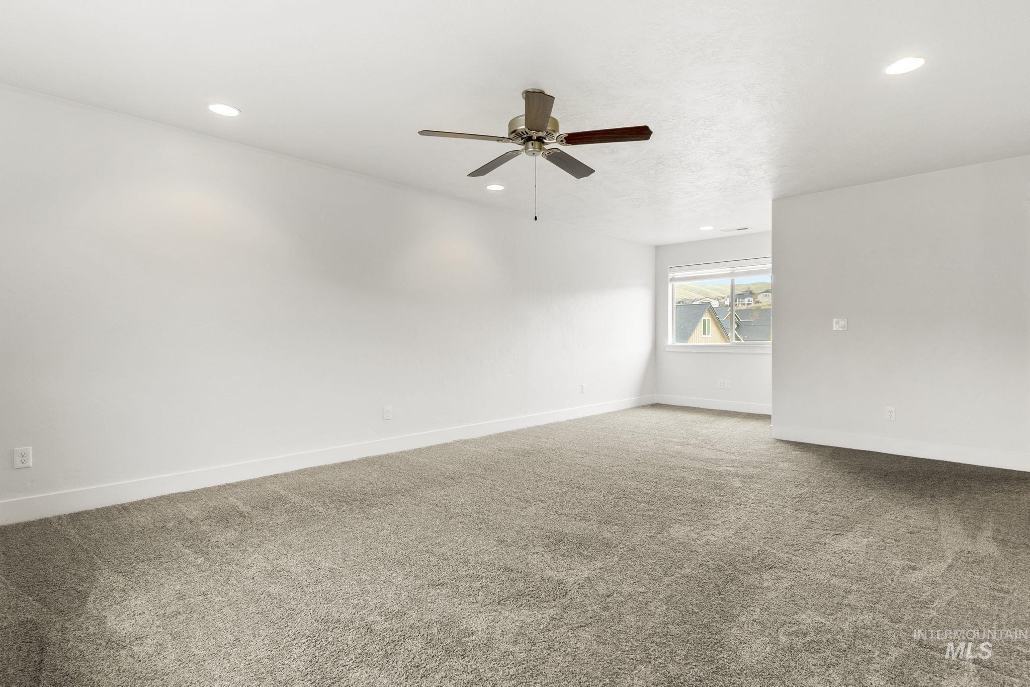 18293 North Streams Edge Way Boise, ID 83714 - Photo 24 of 50 Carpeted spare room featuring a ceiling fan and recessed lighting