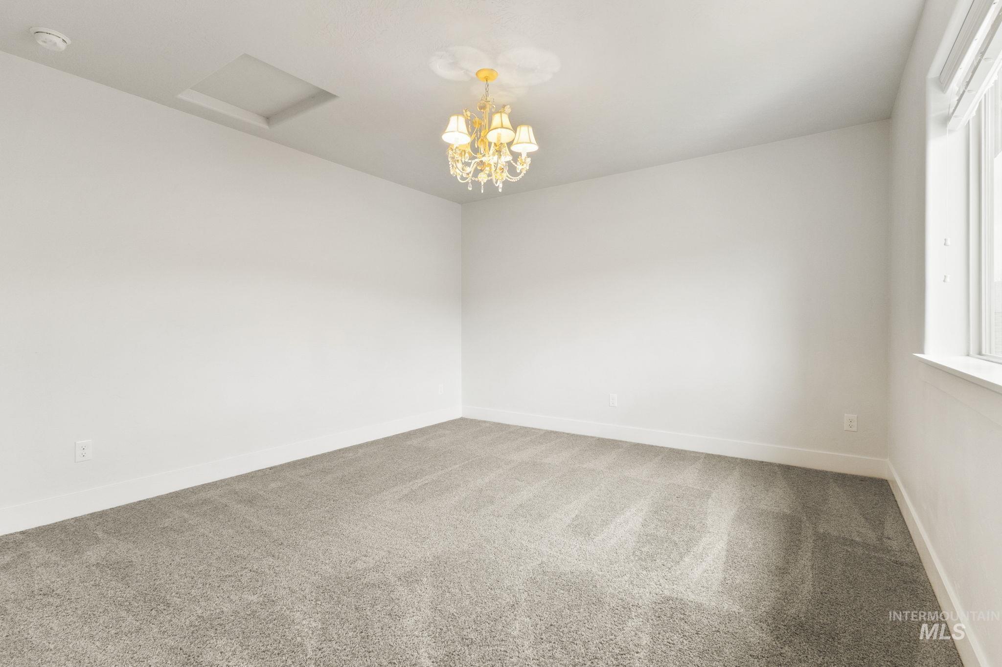 18293 North Streams Edge Way Boise, ID 83714 - Photo 26 of 50 Spare room with carpet and a chandelier