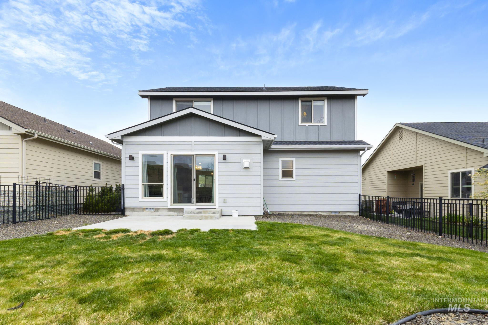 18293 North Streams Edge Way Boise, ID 83714 - Photo 34 of 50 Back of property with board and batten siding, a fenced backyard, a patio, and a shingled roof