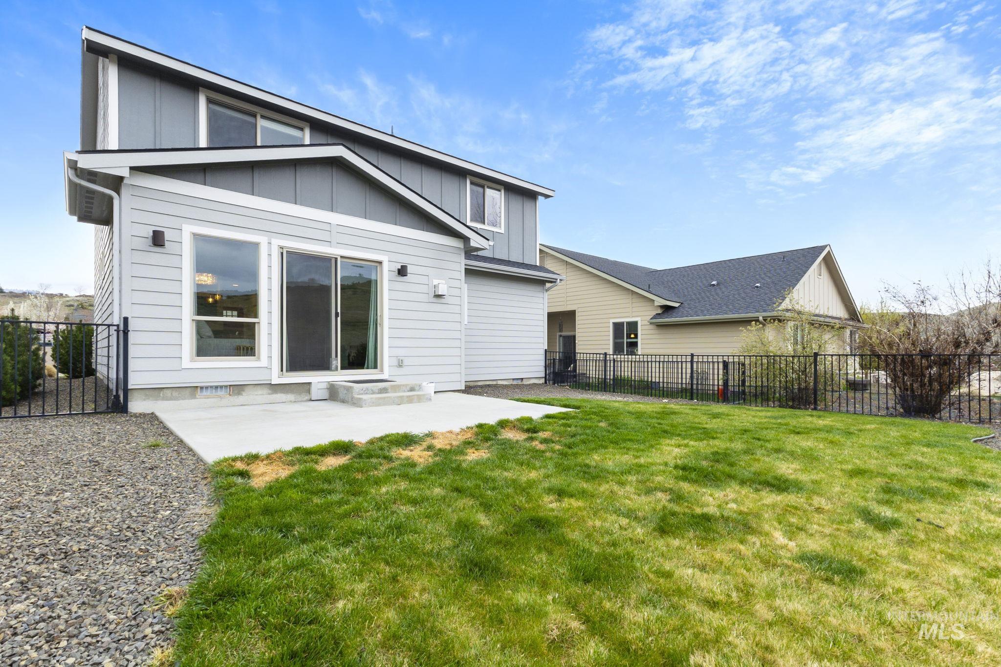 18293 North Streams Edge Way Boise, ID 83714 - Photo 36 of 50 Back of property featuring board and batten siding, a patio, and a fenced backyard