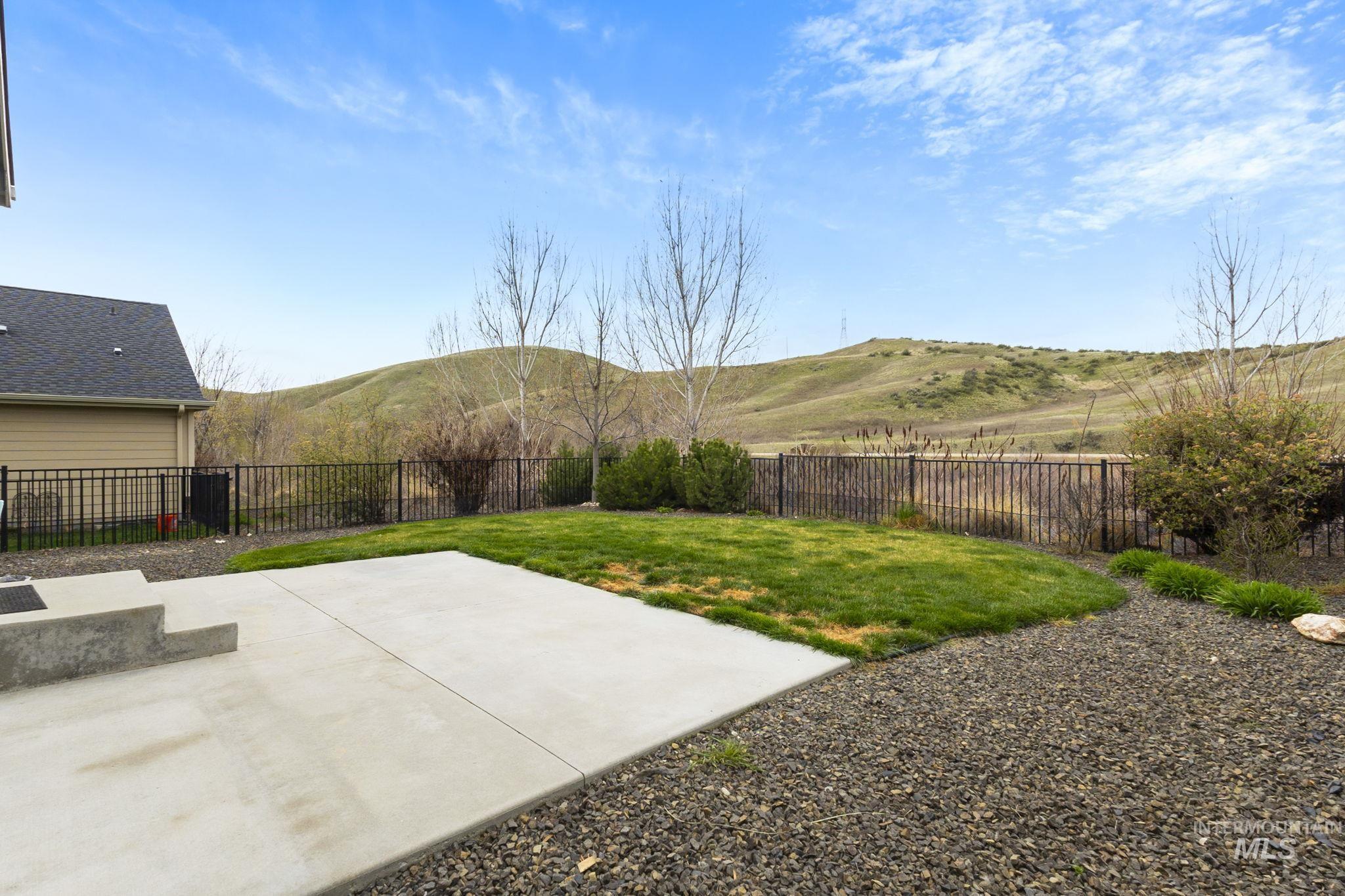 18293 North Streams Edge Way Boise, ID 83714 - Photo 37 of 50 Fenced backyard with a patio area and a mountain view