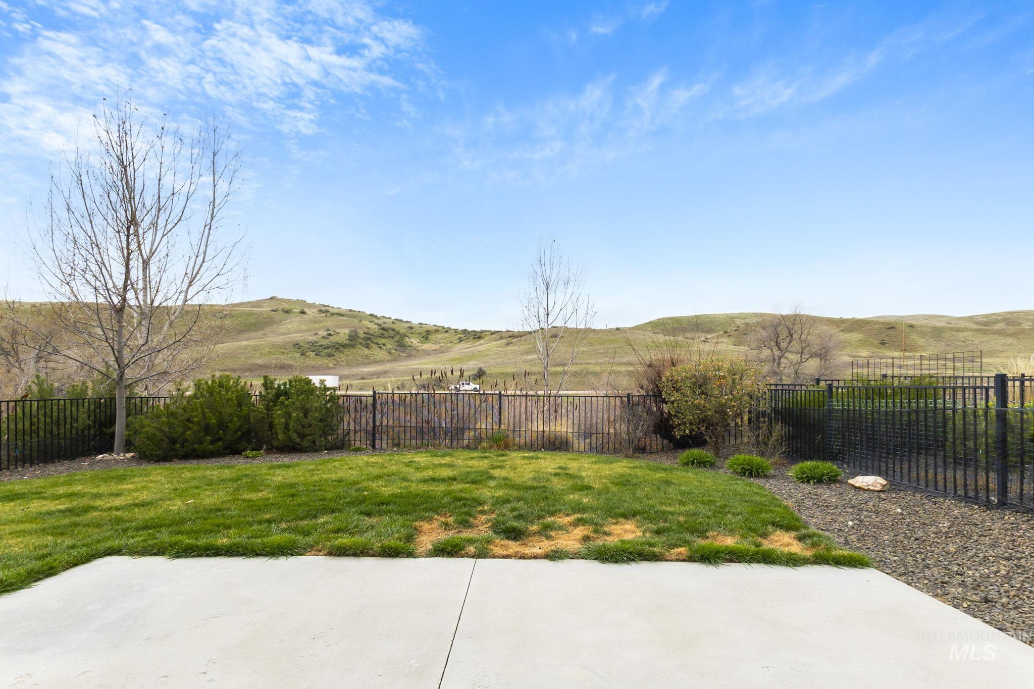 18293 North Streams Edge Way Boise, ID 83714 - Photo 38 of 50 Fenced backyard with a view of countryside and a patio area