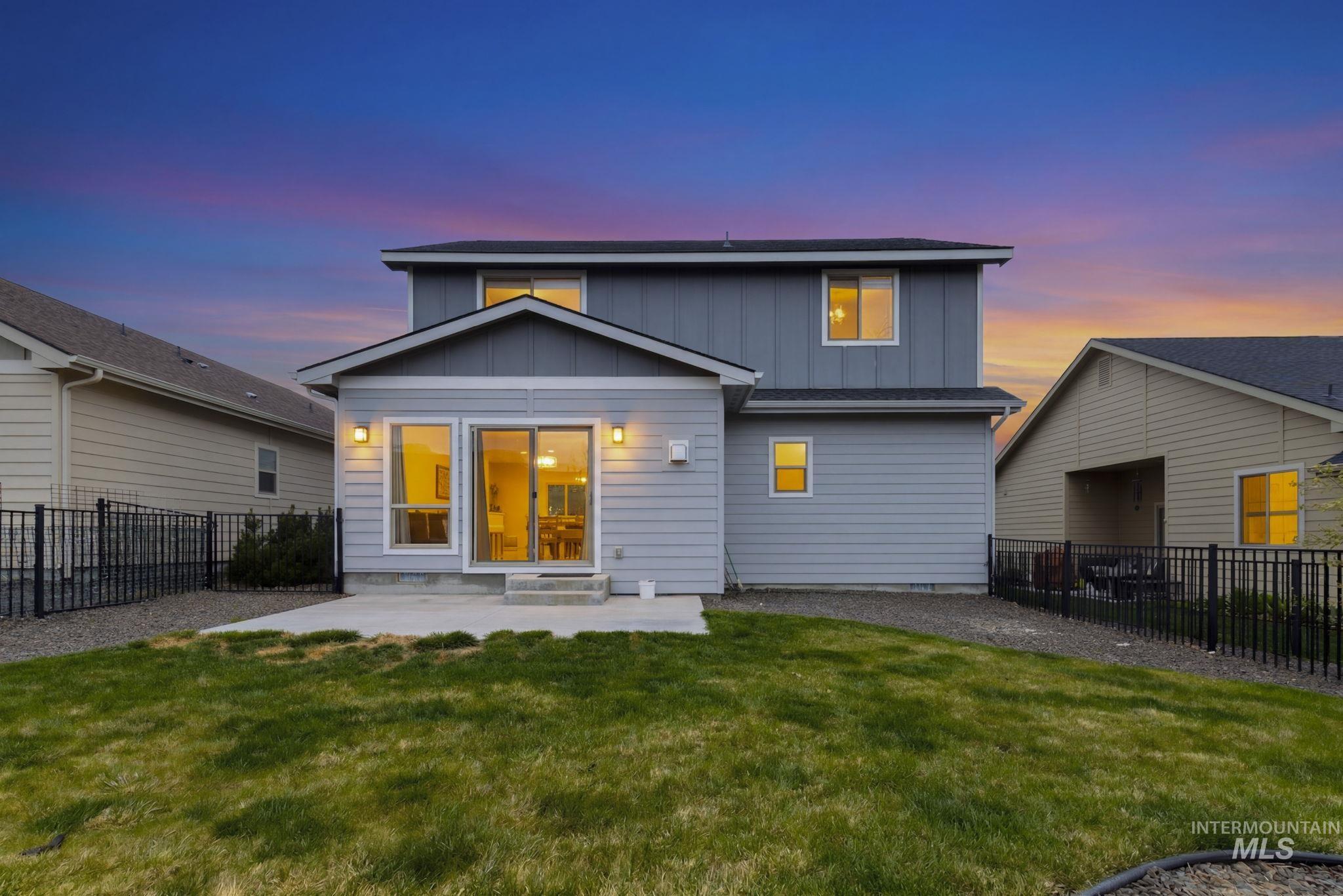 18293 North Streams Edge Way Boise, ID 83714 - Photo 40 of 50 Back of property featuring board and batten siding, a fenced backyard, and a patio area