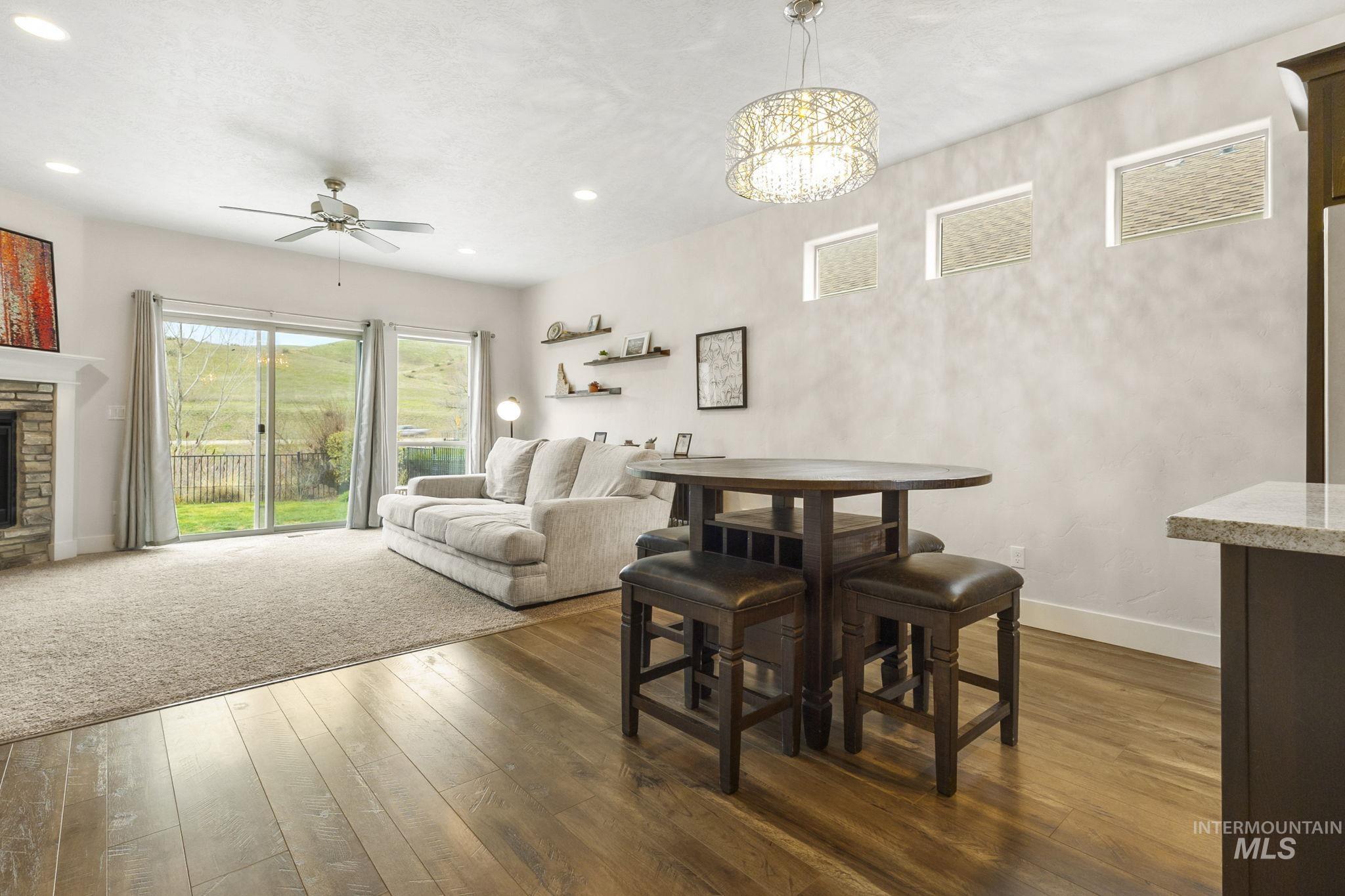 18293 North Streams Edge Way Boise, ID 83714 - Photo 6 of 50 Dining room with dark wood finished floors, ceiling fan, and a fireplace