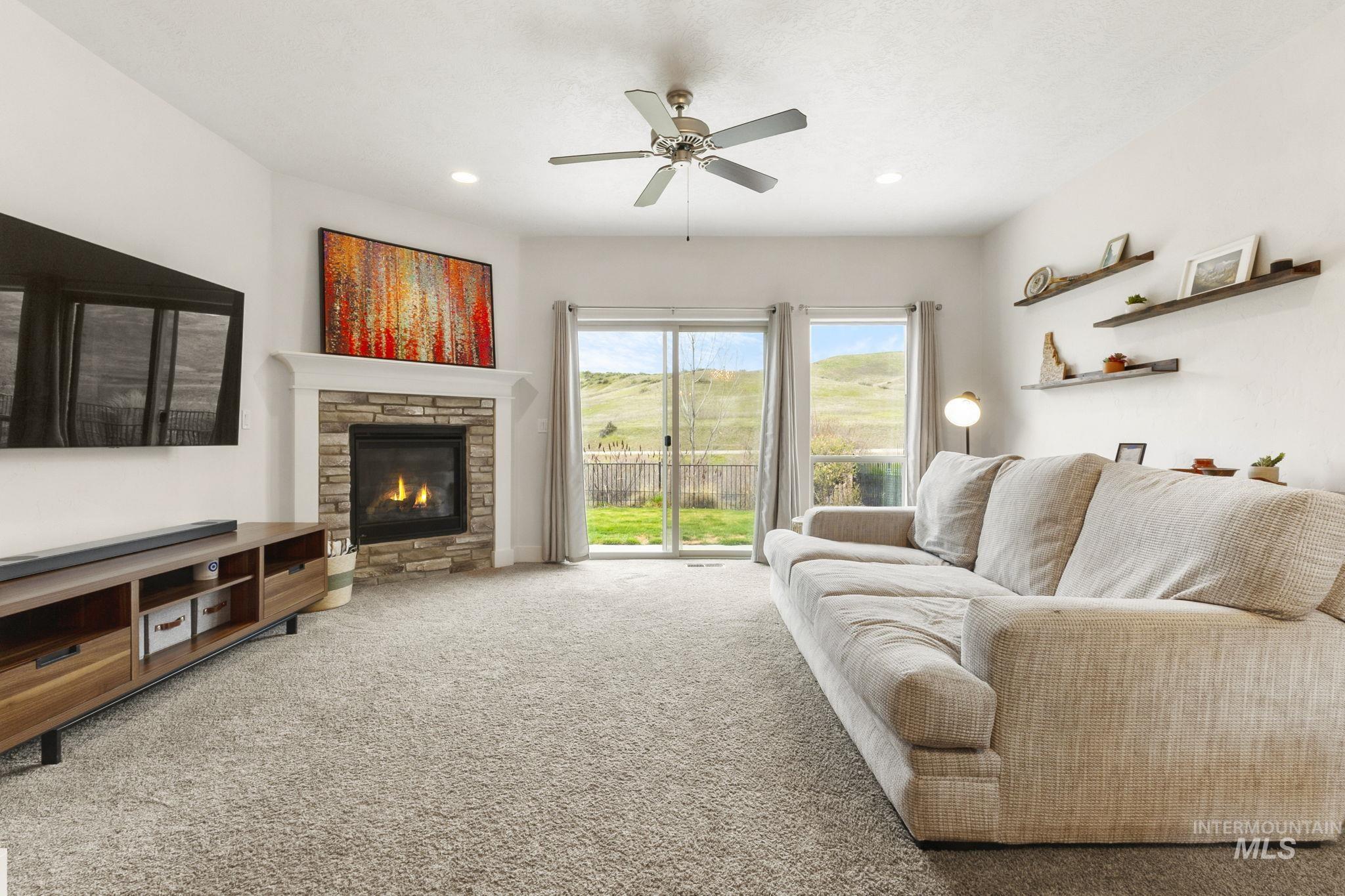 18293 North Streams Edge Way Boise, ID 83714 - Photo 7 of 50 Living area with ceiling fan, carpet flooring, a fireplace, and recessed lighting