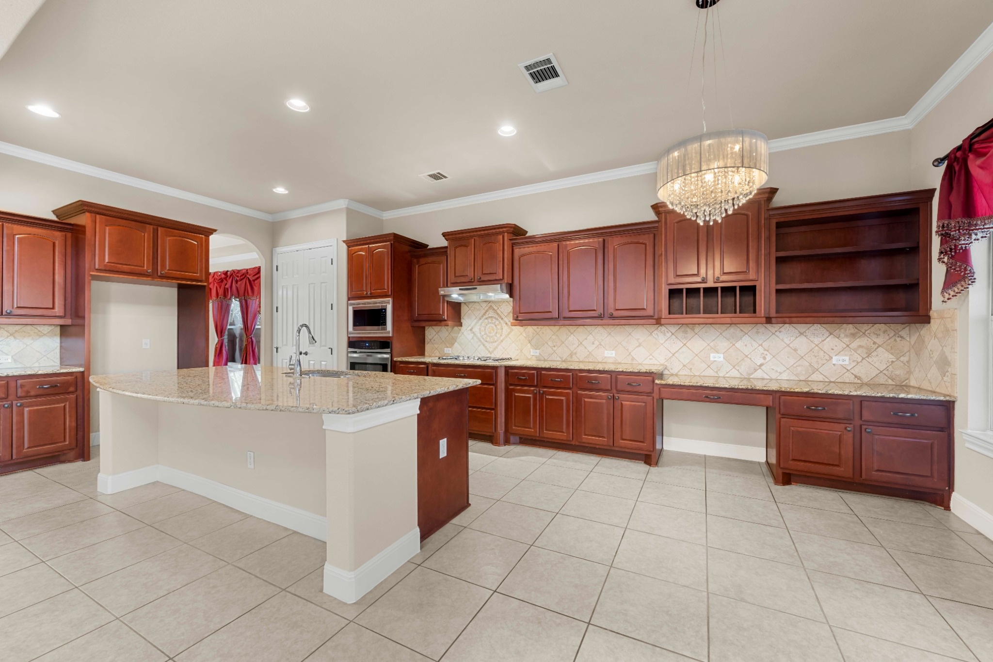 3903 Remington Road Cedar Park, TX 78613 - Photo 10 of 29 A well-appointed kitchen showcasing a spacious island with granite counters and rich wood cabinetry.