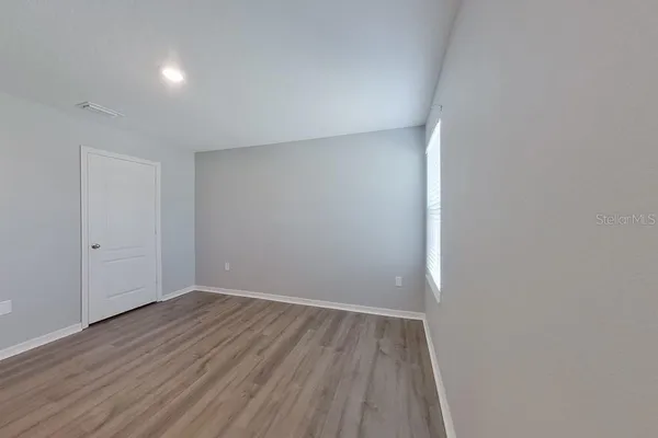 a view of room with wooden floor