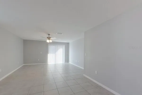 a view of an empty room with a ceiling fan