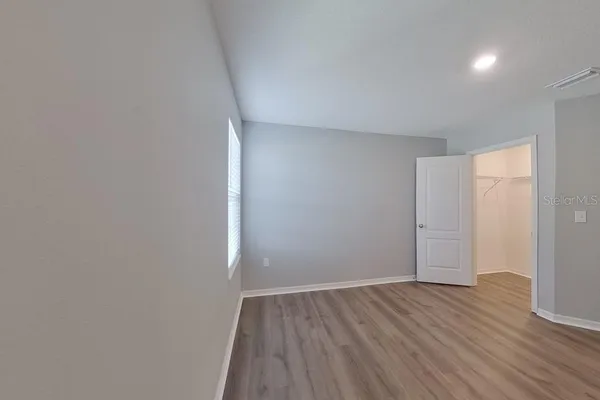 wooden floor in a hall with an empty room