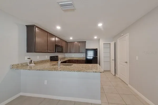 a large bathroom with a sink a large mirror and a shower