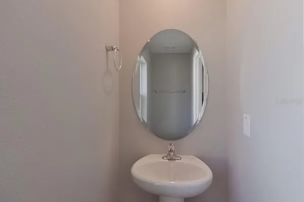 a bathroom with a sink and mirror