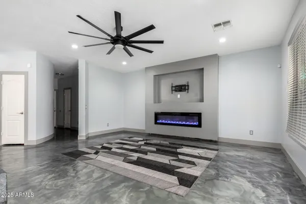 a kitchen with stainless steel appliances kitchen island granite countertop a refrigerator and a sink