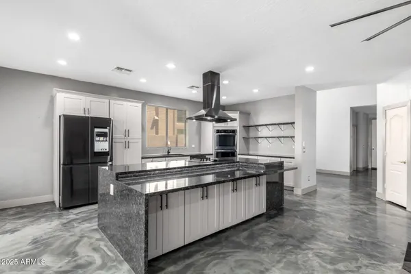 a kitchen with white cabinets and appliances