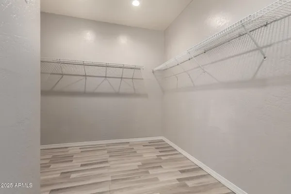 an empty room with a window and ceiling fan