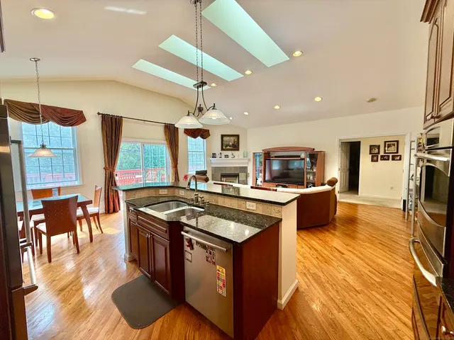 a kitchen with stainless steel appliances granite countertop a stove and a refrigerator