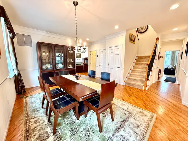 a dining room with furniture window and wooden floor