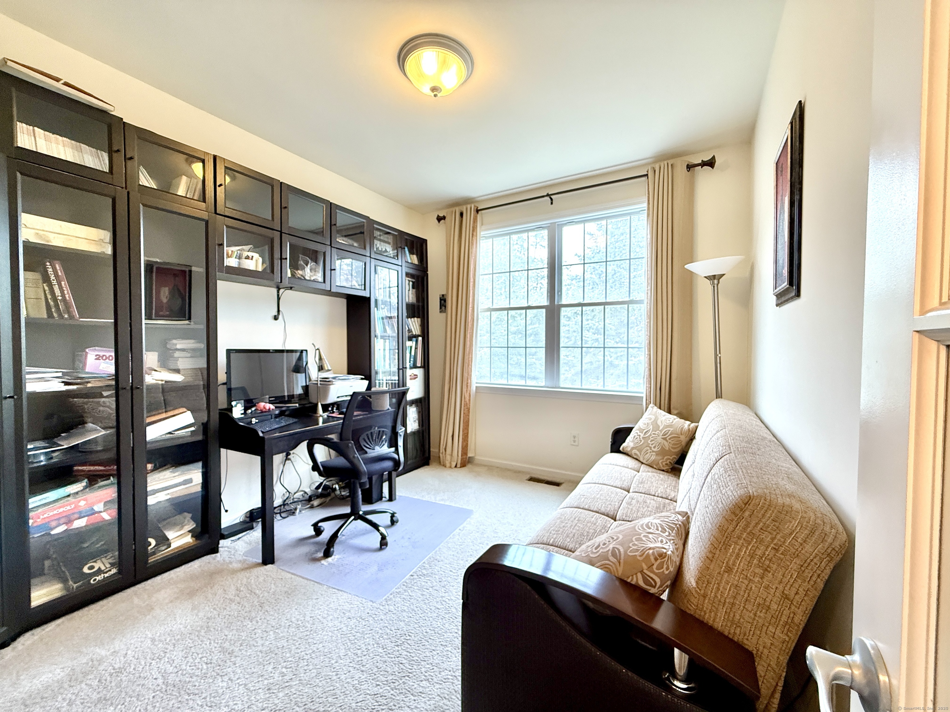 18 Fieldstone Lane, Unit 18 Beacon Falls, CT 06403 - Photo 26 of 40 a living room with furniture and a floor to ceiling window