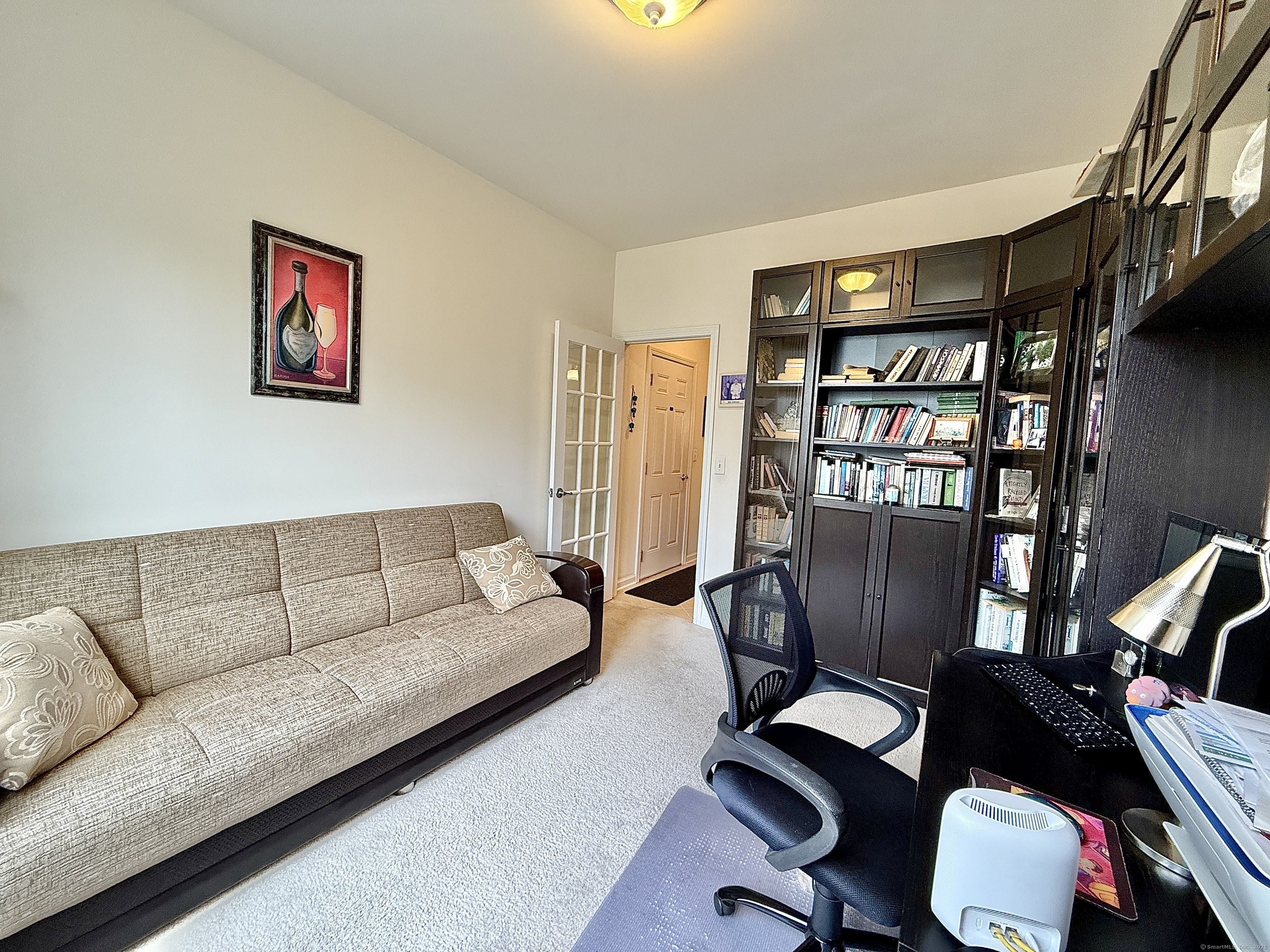 18 Fieldstone Lane, Unit 18 Beacon Falls, CT 06403 - Photo 38 of 40 a living room with furniture a rug and a book shelf