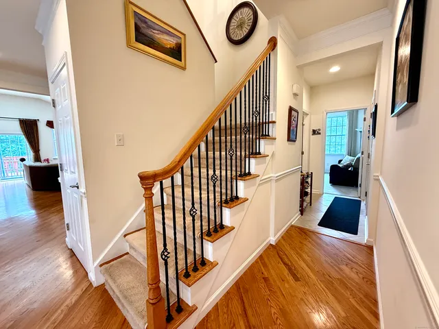 a view of entryway and hall with wooden floor