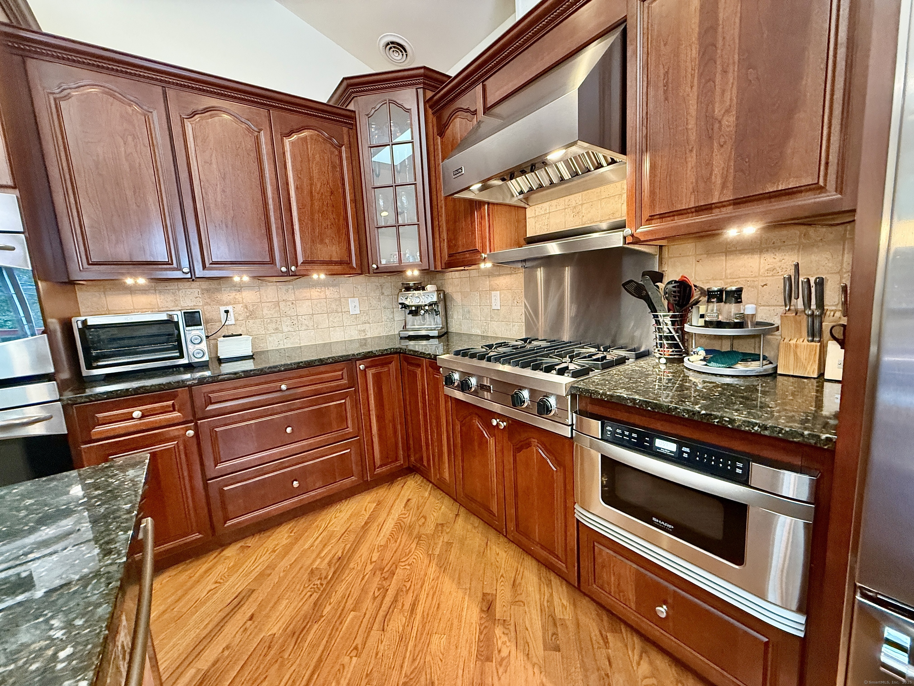18 Fieldstone Lane, Unit 18 Beacon Falls, CT 06403 - Photo 10 of 40 a kitchen with wooden cabinets and a stove top oven