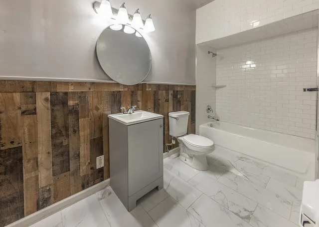 a bathroom with a toilet sink and shower