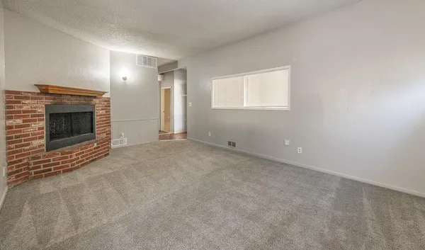 a view of empty room with a fireplace