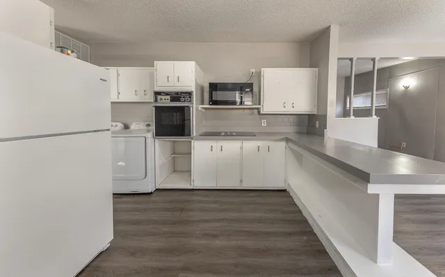 a view of a kitchen with stainless steel appliances a refrigerator and a sink
