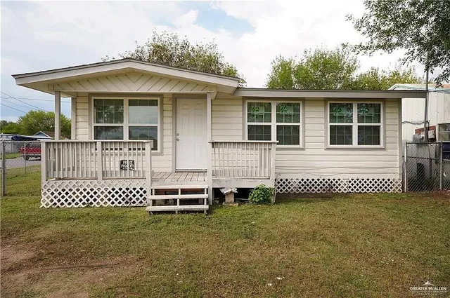 front view of a house with a bench