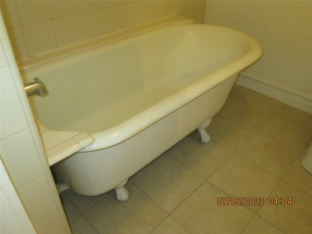 203 North Colson Street, Unit 4 Dallas, TX 75246 - Photo 11 of 15 Full bathroom featuring a soaking tub and tile patterned flooring