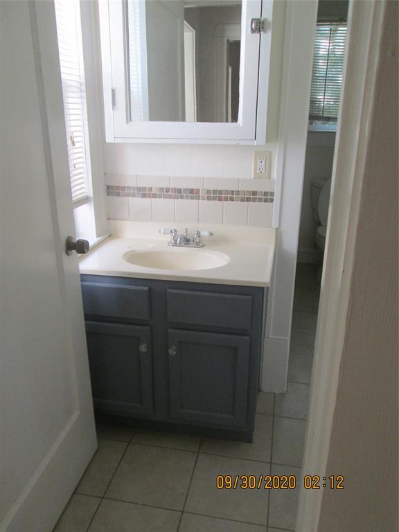 203 North Colson Street, Unit 4 Dallas, TX 75246 - Photo 12 of 15 Bathroom with tile patterned flooring and vanity
