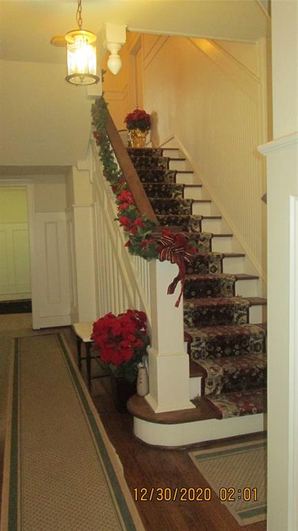 203 North Colson Street, Unit 4 Dallas, TX 75246 - Photo 3 of 15 Staircase with wood finished floors